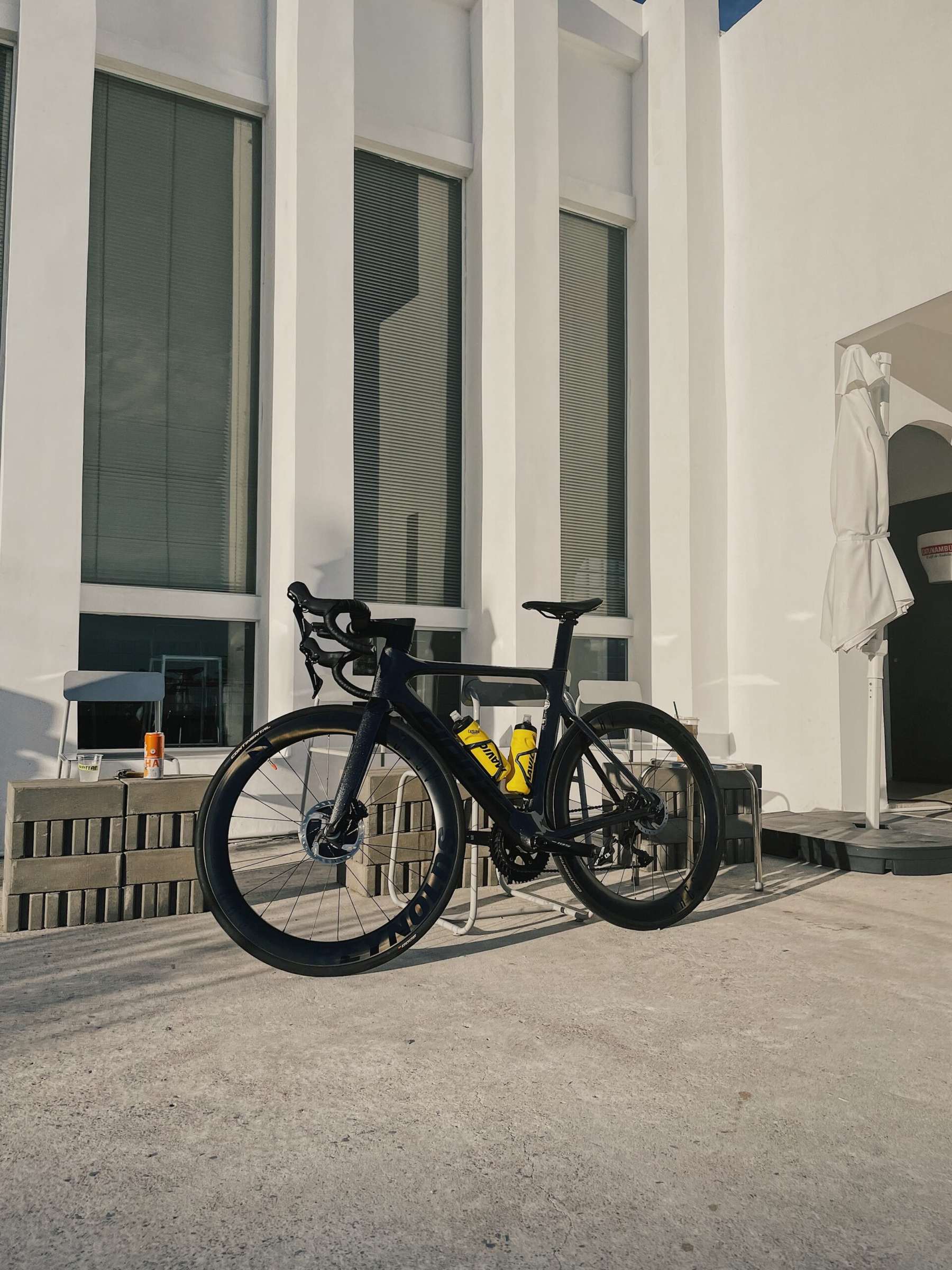 A road bike leaning against a wall on a Bangkok terrace