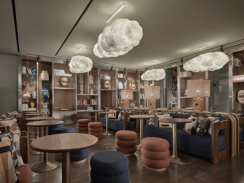 The FORUM coworking floor at Public House Bangkok, with cloud lights above round tables and low stools