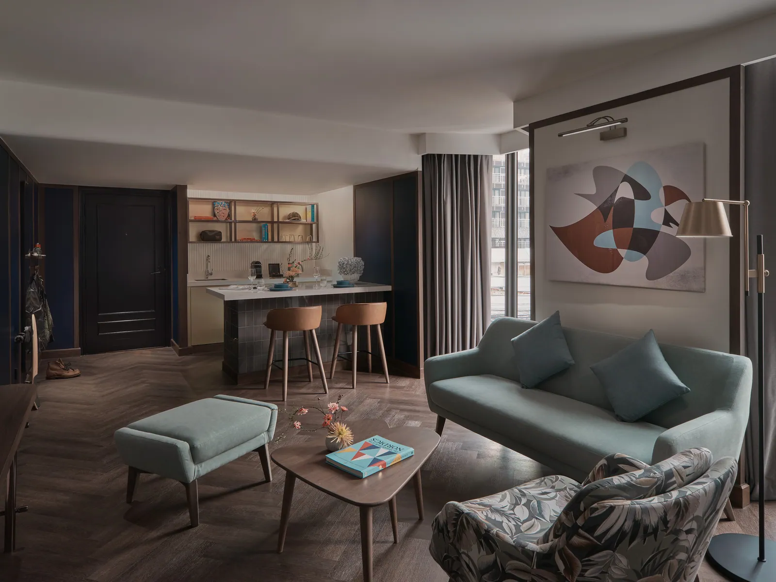 A suite living room at Public House Bangkok, sofa and low table beside the work counter